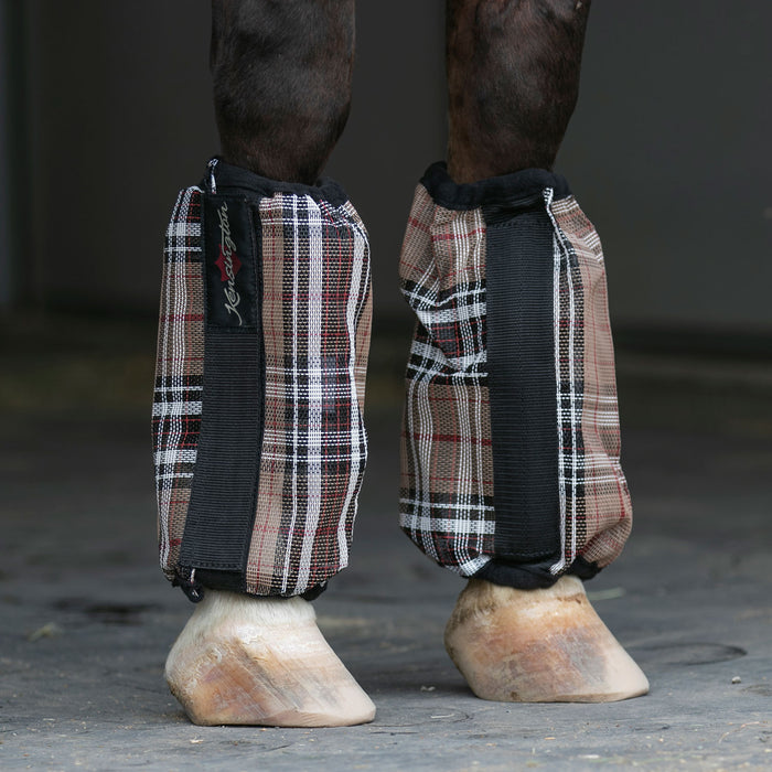 Black and tan bubble fly boots on horse leg.
