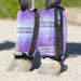 Purple bubble fly boots on horse leg.